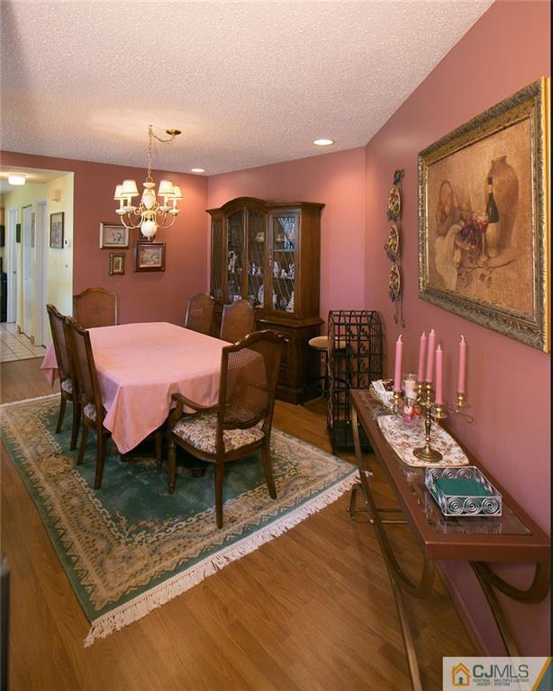 154 Westgate Drive Edison, NJ 08820 - Photo 6 of 19 a dining room with furniture and chandelier