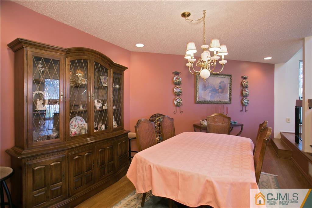 154 Westgate Drive Edison, NJ 08820 - Photo 7 of 19 a bedroom with a bed and dresser with mirror