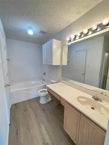 a bathroom with a sink a toilet and mirror