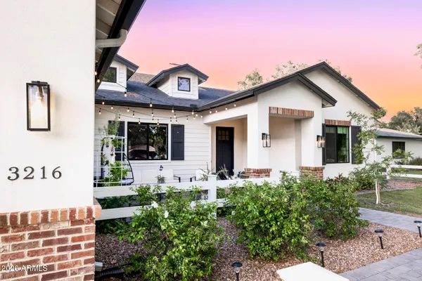 a bedroom with a bed dresser and wooden floor