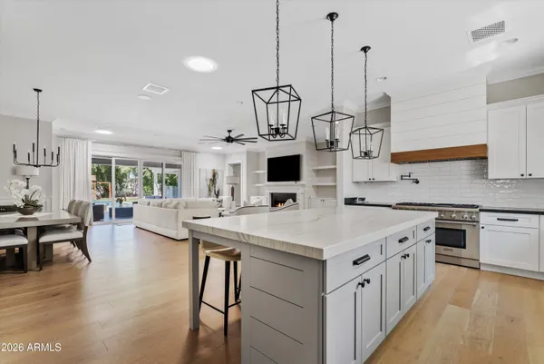 a view of empty room with wooden floor and ceiling fan