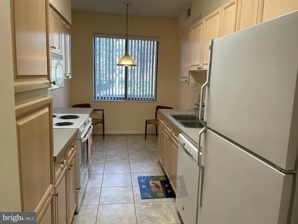 a kitchen with a refrigerator and a stove