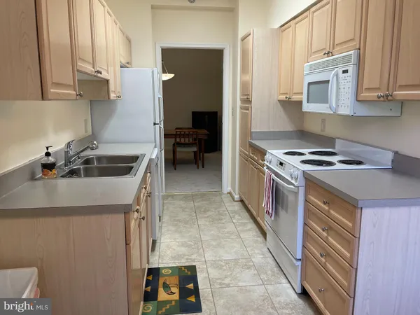 a kitchen that has a sink and a stove in it