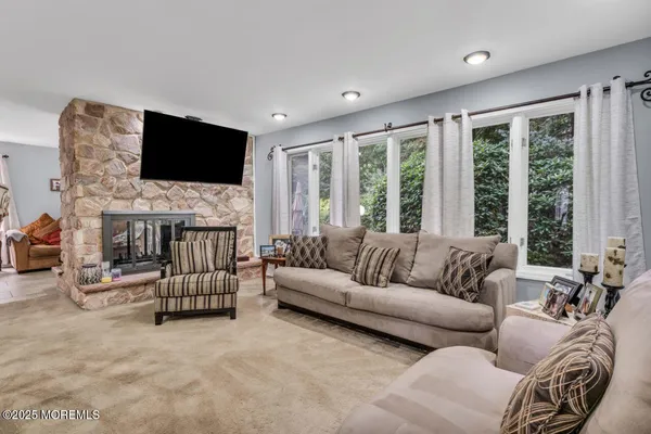 a living room with furniture fireplace and a flat screen tv