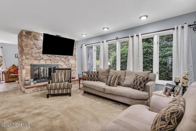 a living room with furniture fireplace and a flat screen tv