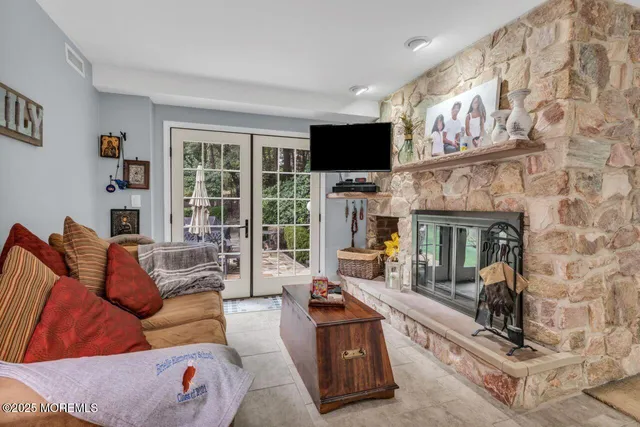 a living room with furniture a flat screen tv and a fireplace