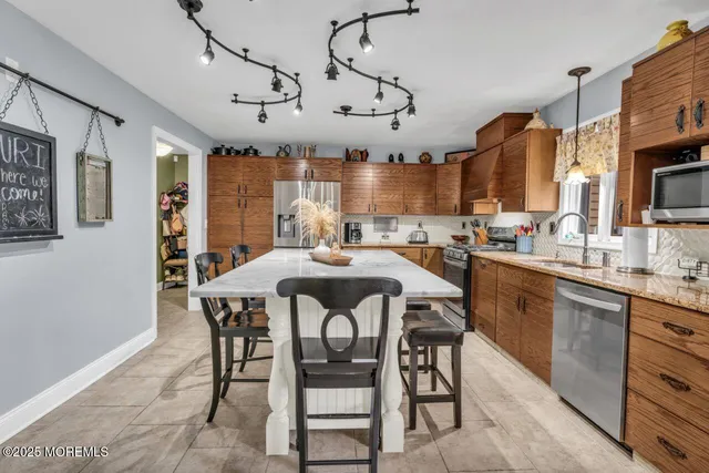 a dining table with chairs and kitchen view