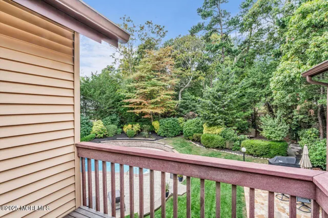 a kitchen with stainless steel appliances granite countertop wooden cabinets a dining table and chairs