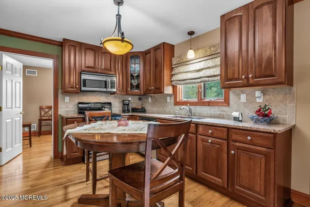 a kitchen with a table chairs stove and cabinets