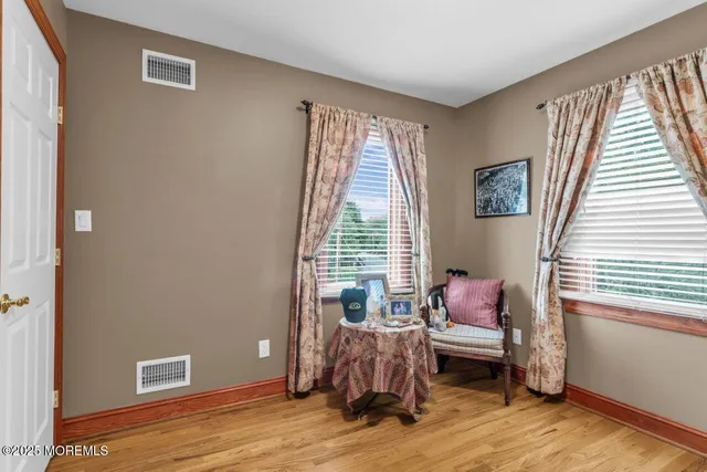 a bedroom with a large bed and a large mirror on the dresser