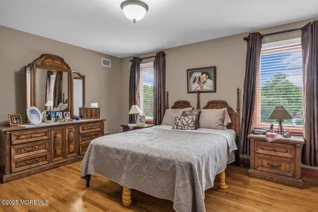 a bathroom with a granite countertop sink and a window