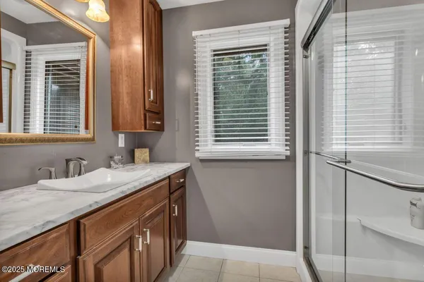 a spacious bedroom with a bed and a flat screen tv
