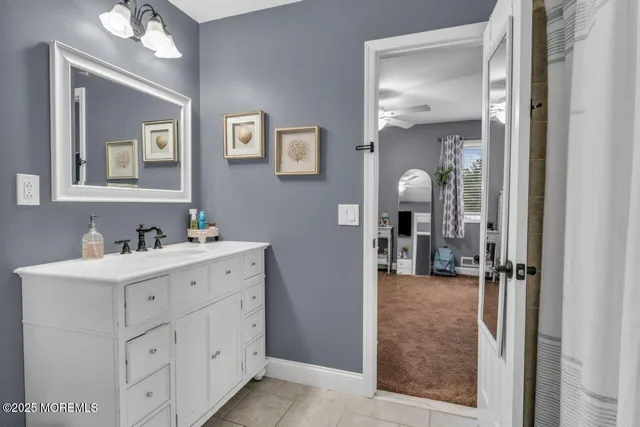 a bedroom with a bed gym equipment and a large window