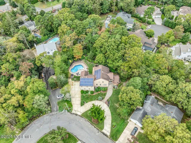 an aerial view of a house with a yard swimming pool