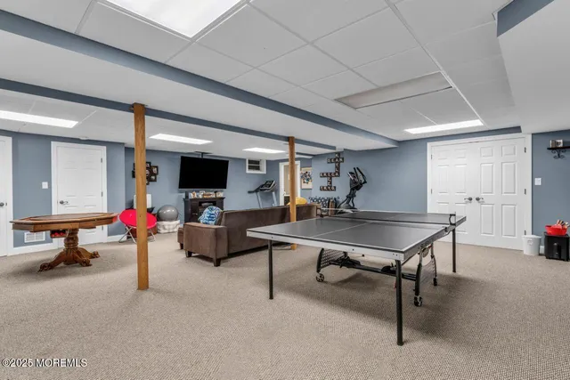 a spacious bedroom with bed and a chandelier