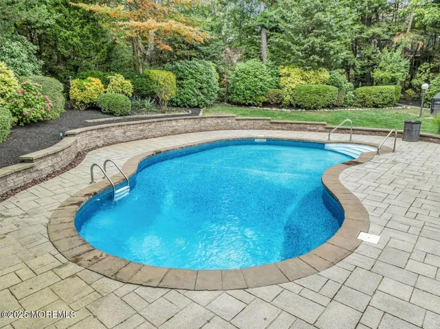 a view of a swimming pool with an outdoor space and seating area
