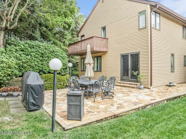 a view of a house with backyard and sitting area