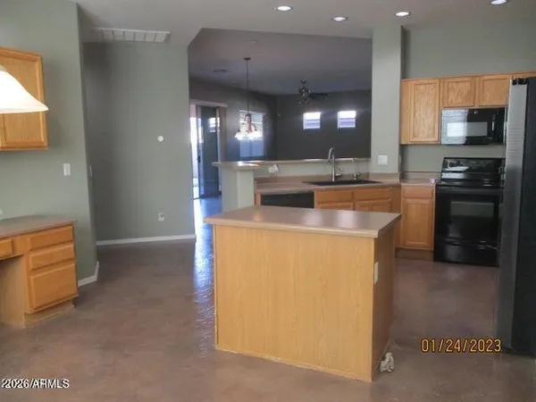 a kitchen with a sink a counter top space stainless steel appliances and cabinets