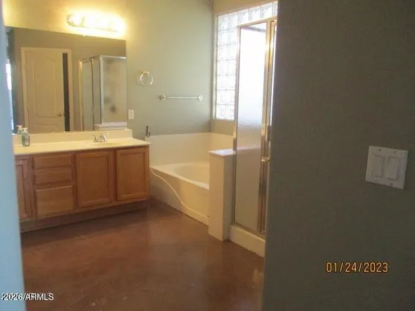 a spacious bathroom with a tub sink shower and mirror