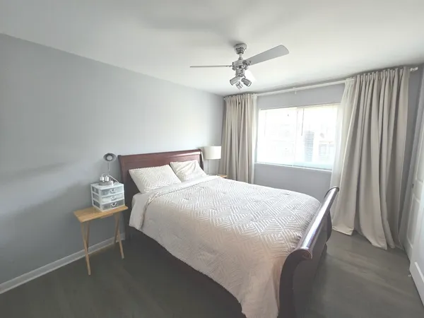 a bedroom with a bed and a window
