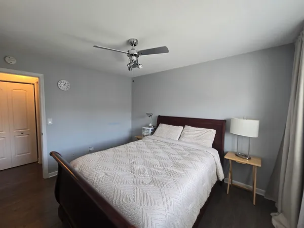 a bedroom with a bed and a chandelier