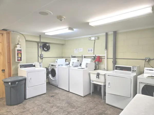 a kitchen with a stove top oven and white cabinets