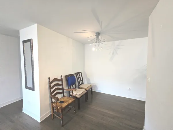 a living room with furniture and a ceiling fan