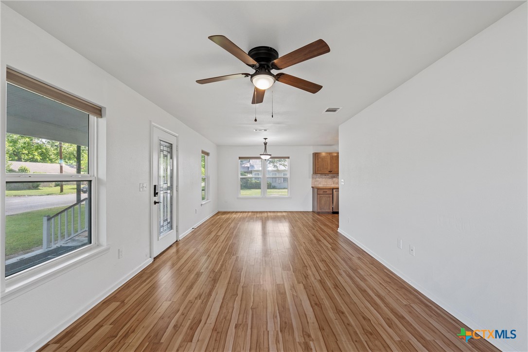 407 East 7th Street Cameron, TX 76520 - Photo 11 of 43 a view of workspace with wooden floor and ceiling fan