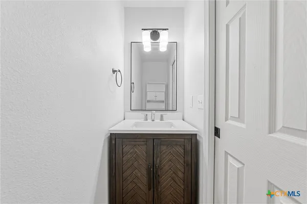 a bathroom with a sink and mirror