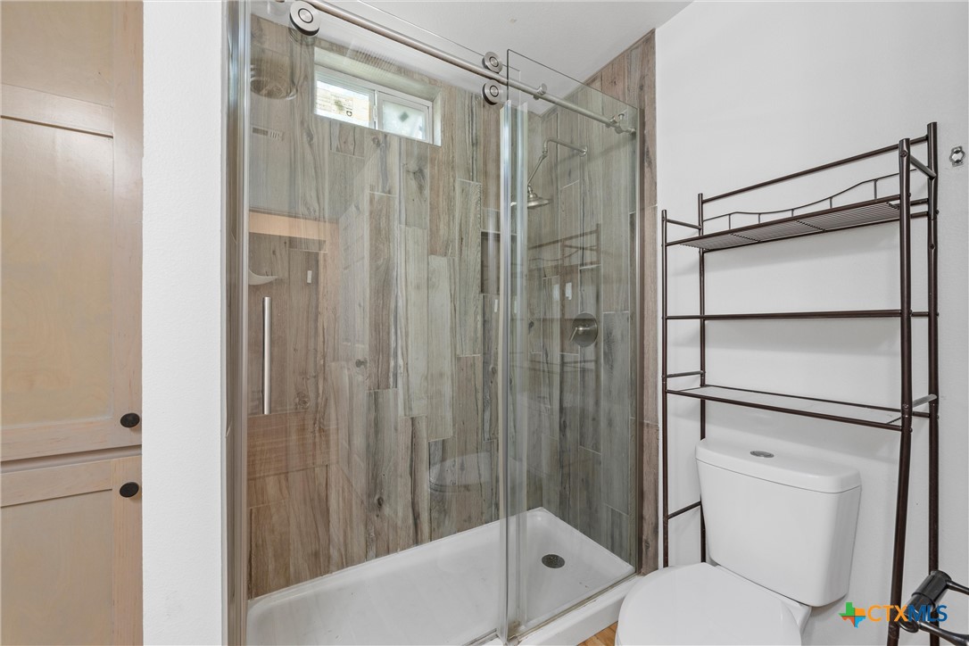 407 East 7th Street Cameron, TX 76520 - Photo 24 of 43 a bathroom with a shower a toilet and a sink