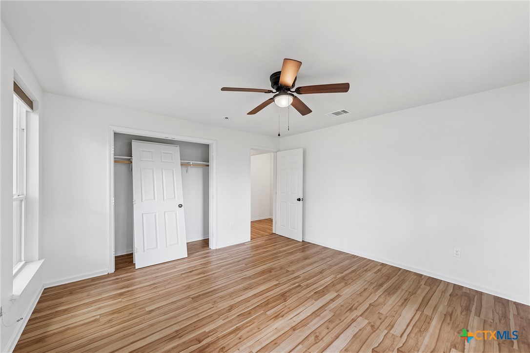 407 East 7th Street Cameron, TX 76520 - Photo 26 of 43 a view of room with wooden floor and ceiling fan