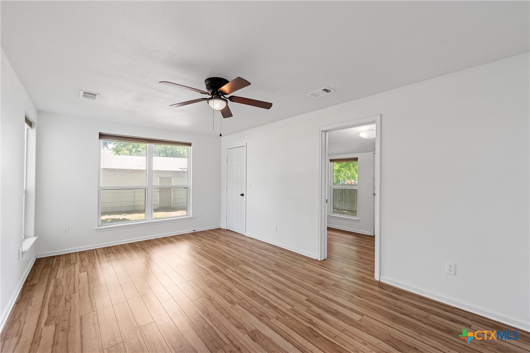407 East 7th Street Cameron, TX 76520 - Photo 27 of 43 a view of empty room with wooden floor and fan