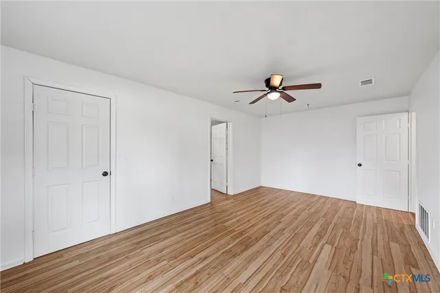 an aerial view of residential houses with outdoor space and trees