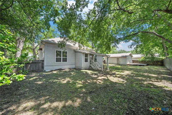 a view of a backyard with a tree