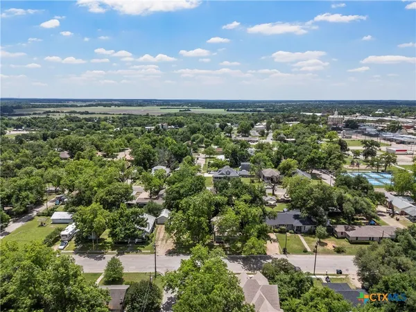 an aerial view of a houses with a yard