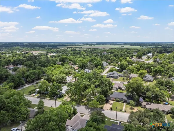 an aerial view of a houses with a lake view