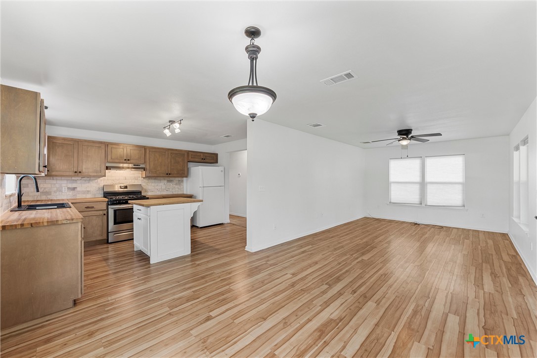 407 East 7th Street Cameron, TX 76520 - Photo 8 of 43 a view of a kitchen with sink and wooden floor