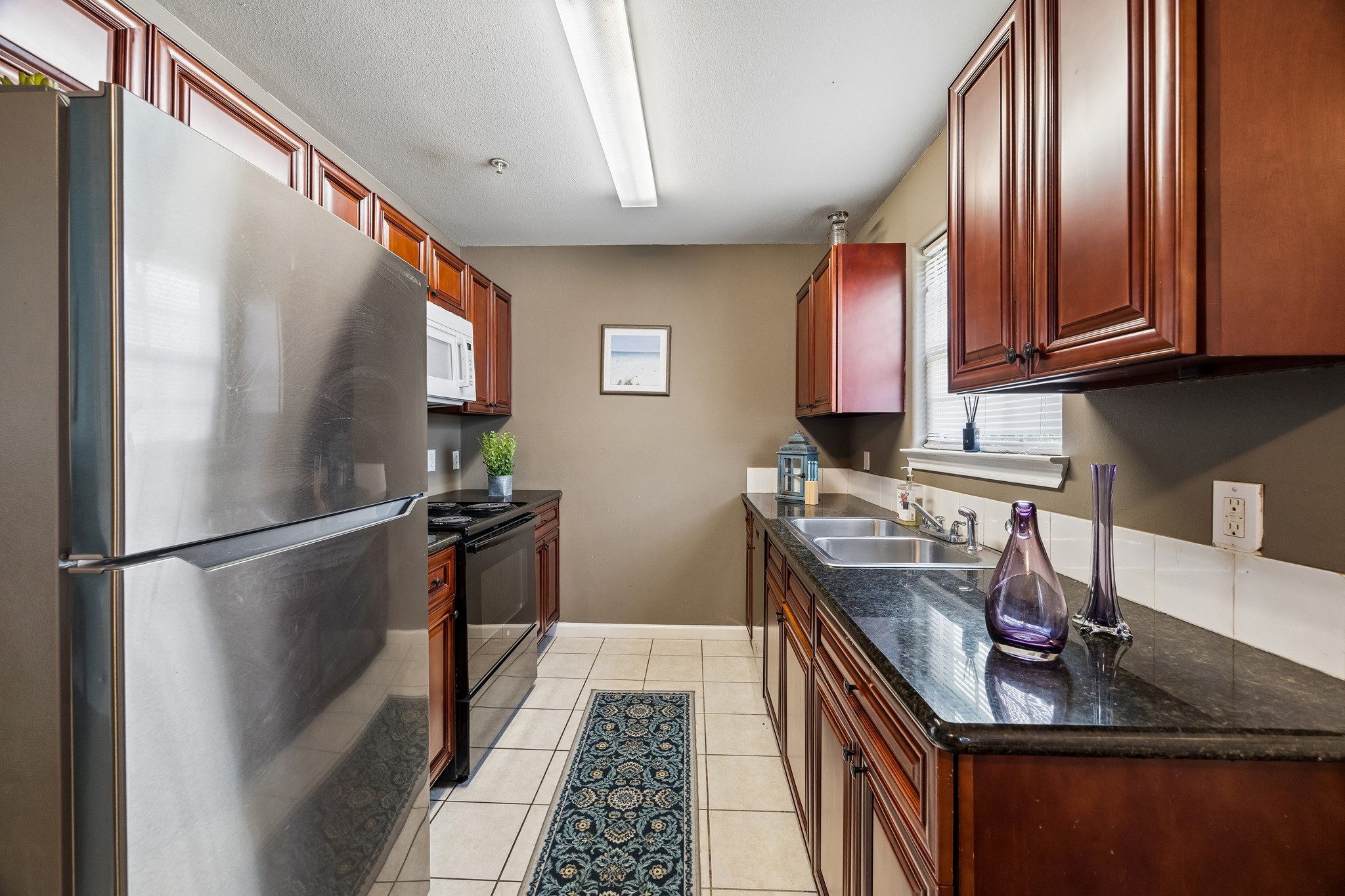 2013 Ellis School Road Baytown, TX 77521 - Photo 14 of 31 Well-appointed kitchen offers ample workspace and everyday functionality, efficient kitchen layout makes meal preparation and hosting easy. Fully equipped kitchen combines practical storage with a welcoming design.