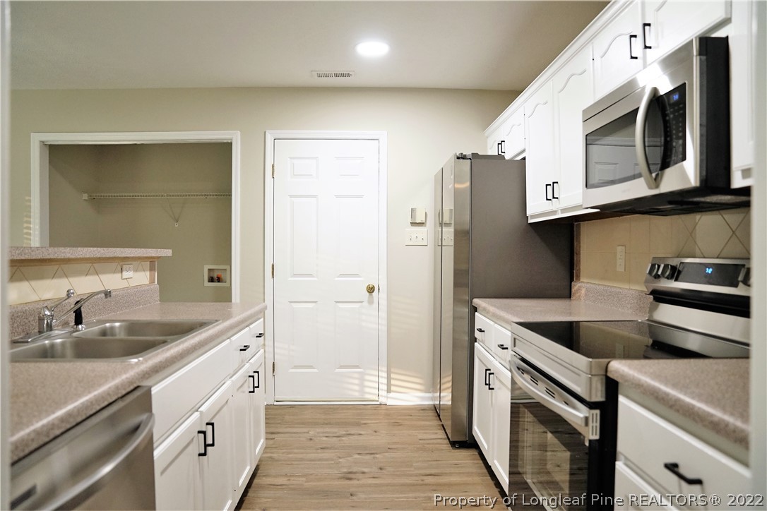 2940 Bakers Mill Road Fayetteville, NC 28306 - Photo 11 of 46 a kitchen with stainless steel appliances granite countertop a sink and a microwave
