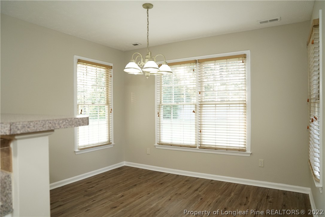 2940 Bakers Mill Road Fayetteville, NC 28306 - Photo 16 of 46 a view of an empty room with wooden floor and a window