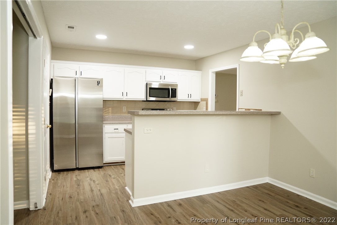 2940 Bakers Mill Road Fayetteville, NC 28306 - Photo 18 of 46 a kitchen with granite countertop a refrigerator and a sink