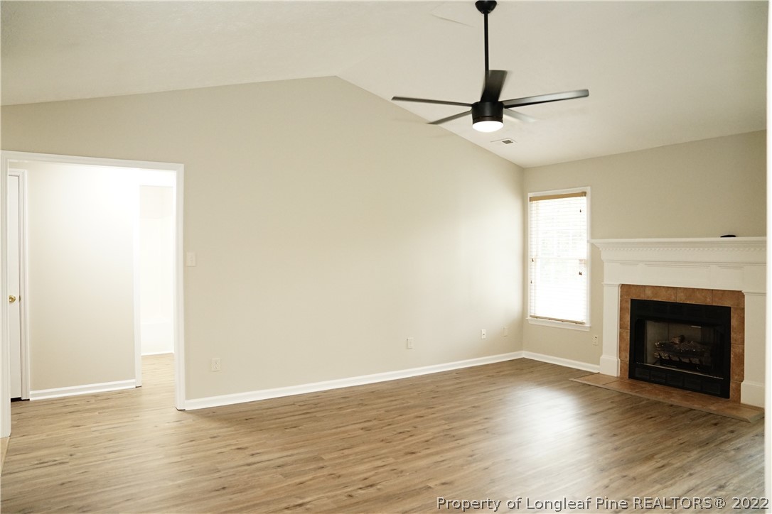 2940 Bakers Mill Road Fayetteville, NC 28306 - Photo 20 of 46 a view of a room with wooden floor a fireplace and windows