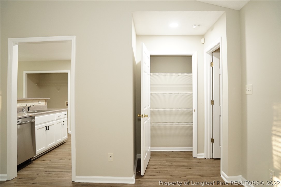 2940 Bakers Mill Road Fayetteville, NC 28306 - Photo 21 of 46 a view of a hallway with wooden floor