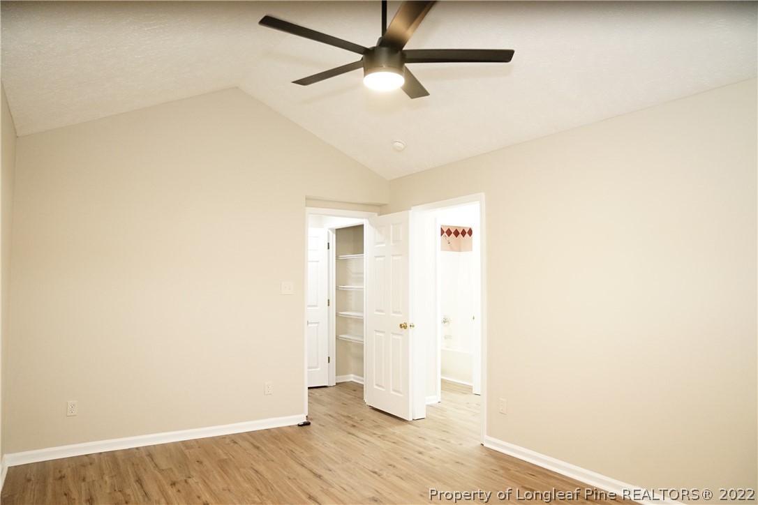 2940 Bakers Mill Road Fayetteville, NC 28306 - Photo 23 of 46 a view of a livingroom with wooden floor and a ceiling fan