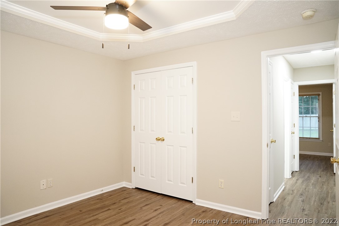 2940 Bakers Mill Road Fayetteville, NC 28306 - Photo 37 of 46 an empty room with wooden floor and ceiling fan