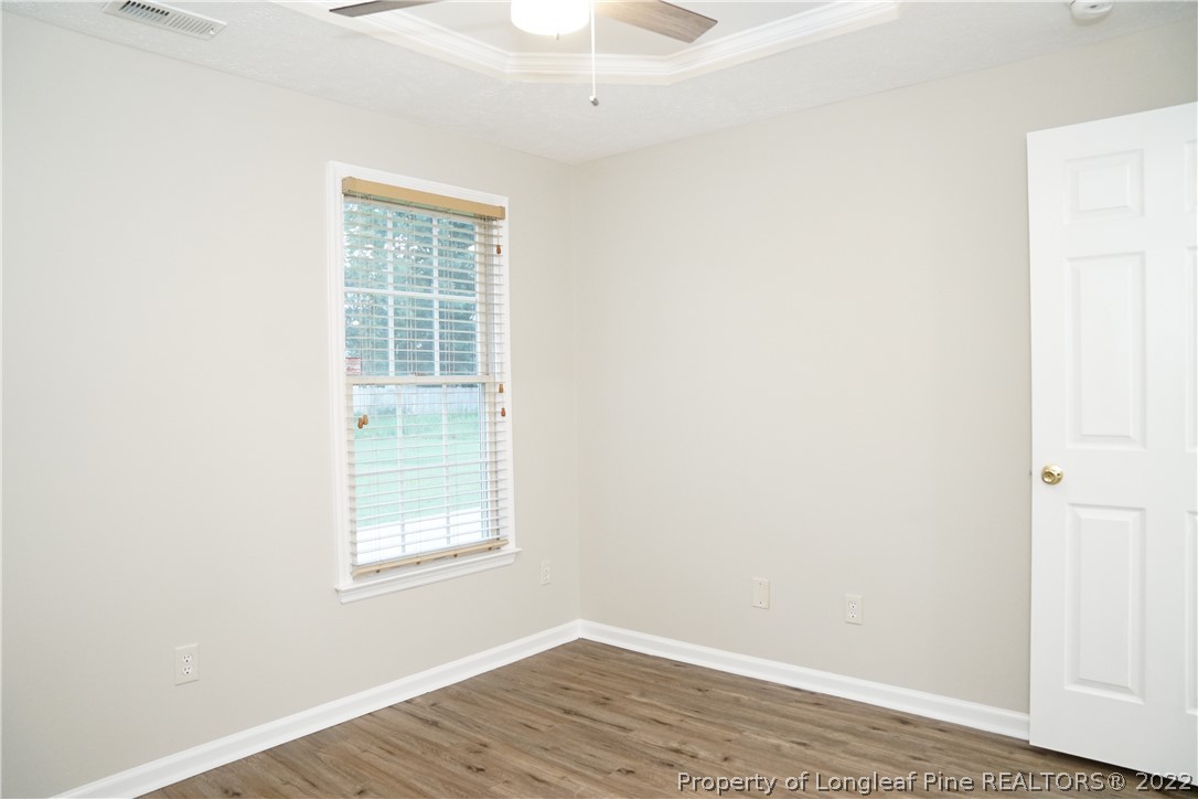 2940 Bakers Mill Road Fayetteville, NC 28306 - Photo 41 of 46 an empty room with wooden floor and a window