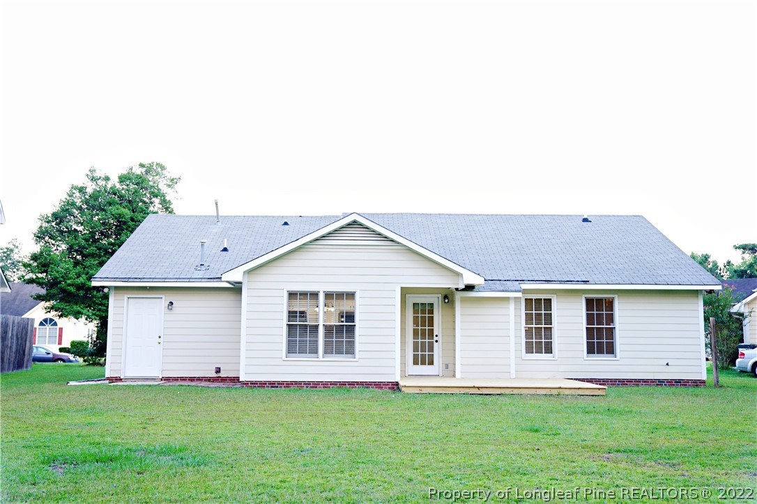 2940 Bakers Mill Road Fayetteville, NC 28306 - Photo 45 of 46 a front view of a house with a garden and deck