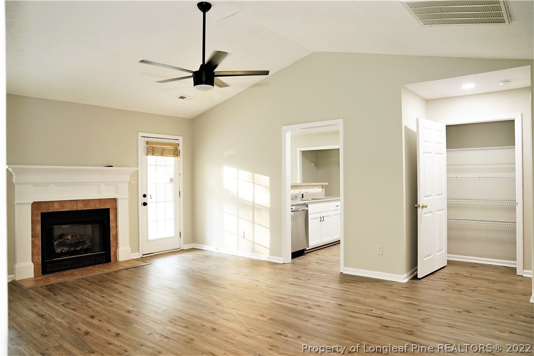 2940 Bakers Mill Road Fayetteville, NC 28306 - Photo 7 of 46 a view of a livingroom with a fireplace wooden floor and windows