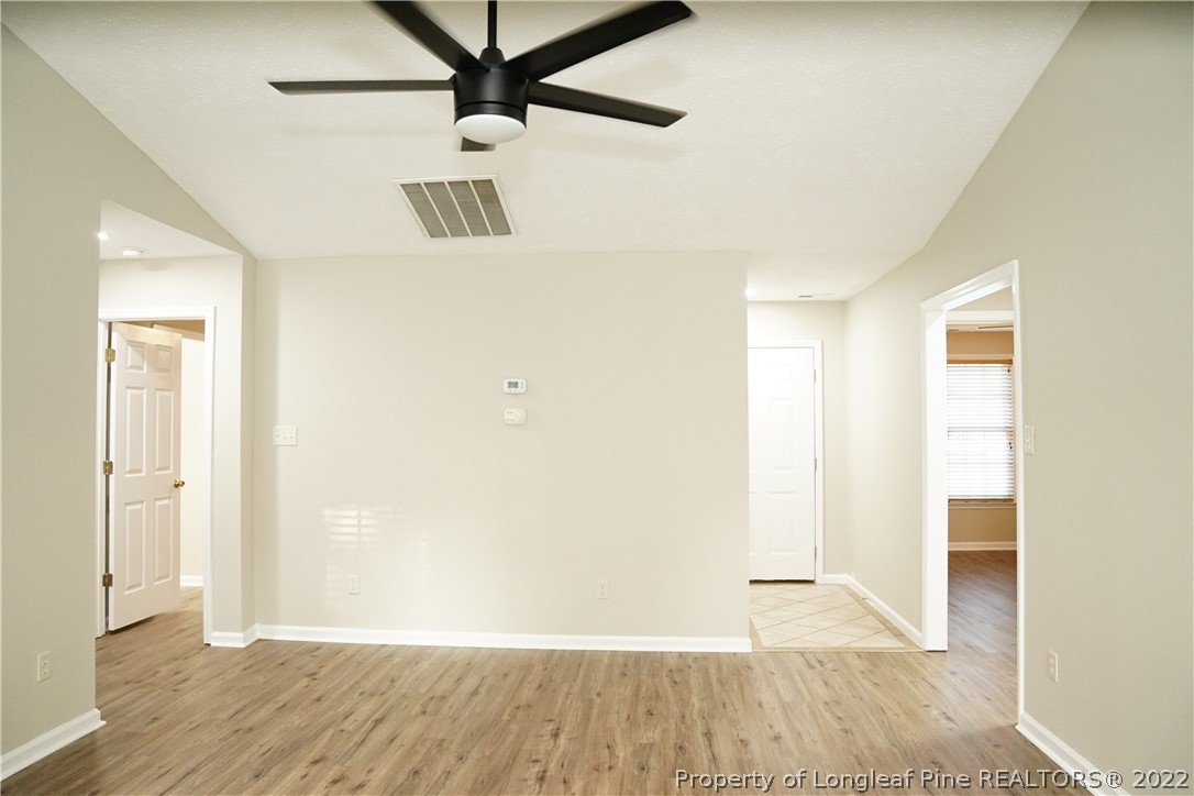2940 Bakers Mill Road Fayetteville, NC 28306 - Photo 10 of 46 an empty room with wooden floor and windows