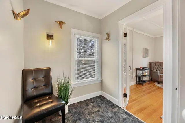 a bedroom with a bed and a flat tv screen on dresser